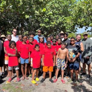 Scott Hadley of the Miramar Police Athletic League, Ryan Goggins and Peter Apol of Sunbeam Properties & Development with campers and police officers